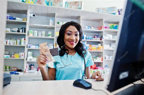 Premium Photo | African american pharmacist working in drugstore at ...