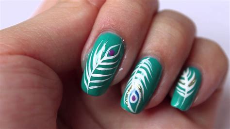 Green Nails With White Peacock Feather Nail Art