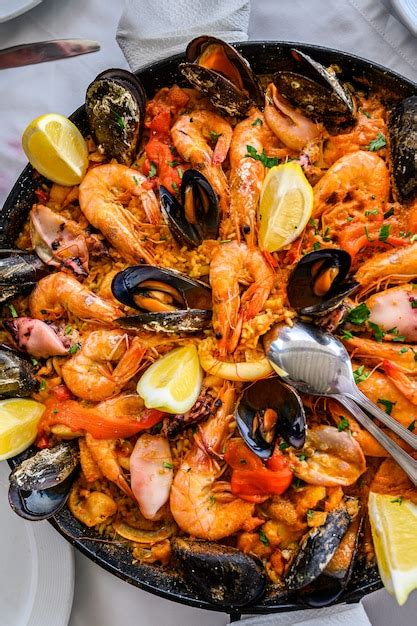 Premium Photo | Spanish seafood paella rice dish with fresh shrimp ...