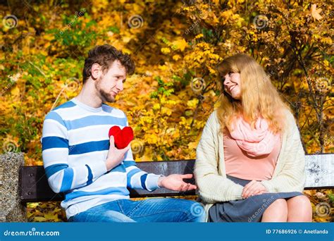 Man Show Feelings To Girl in Autumnal Park. Stock Photo - Image of autumn, love: 77686926