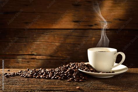 Coffee cup and coffee beans on old wooden background Stock Photo | Adobe Stock