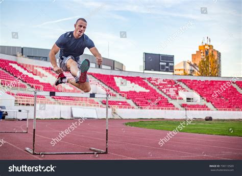 Young Athletic Man Jumping Over Hurdles Stock Photo 738113569 | Shutterstock