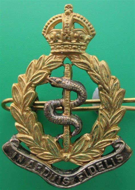 A SILVER AND GILT OFFICER'S RAMC CAP BADGE in Officers Silver Gilt Badges and Collars