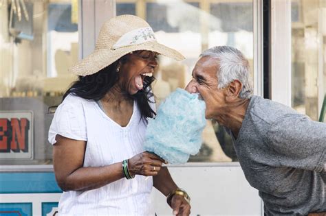 Senior couple eating cotton candy, laughing, Long Beach, California ...