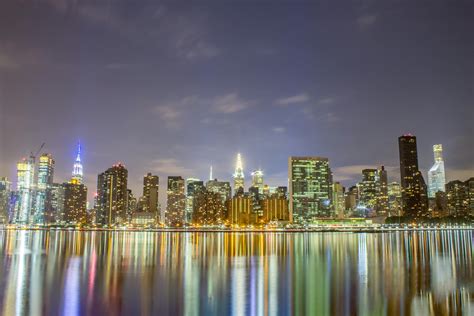 City Skyline Across Body of Water during Night Time · Free Stock Photo