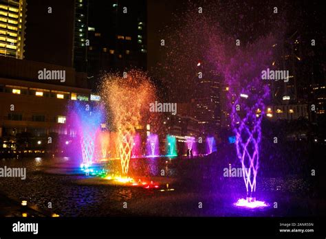 Multi-colored dancing fountains near the twin towers of Petronas in Kuala Lumpur Stock Photo - Alamy