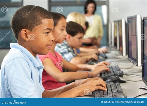 Elementary Students Working at Computers in Classroom Stock Image - Image of black, class: 30851787