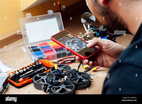 Man Repair A Drone.Engineer repairs a drone at home Stock Photo - Alamy