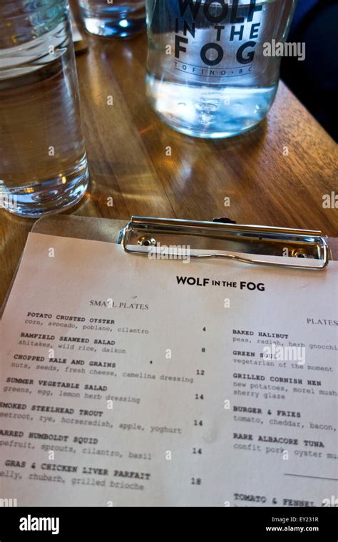 Menu and bottle of water at the Wolf in the Fog, a popular restaurant ...