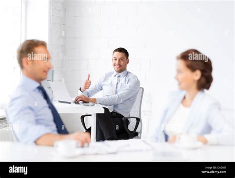 happy businessman showing thumbs up in office Stock Photo - Alamy