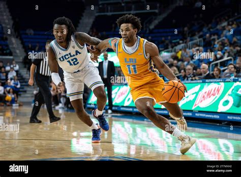 LIU Sharks guard Terell Strickland (11) drives against UCLA Bruins guard Sebastian Mack (12 ...