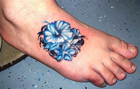 Tribal blue hawaiian hibiscus flower tattoo on foot - Tattooimages.biz