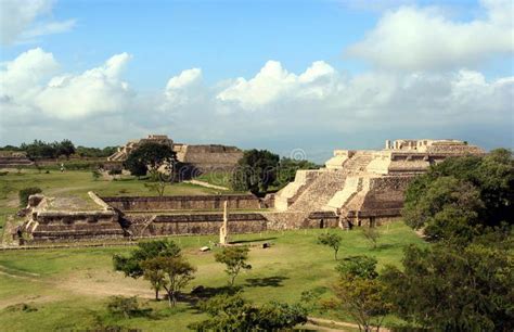 an ancient city surrounded by trees and grass