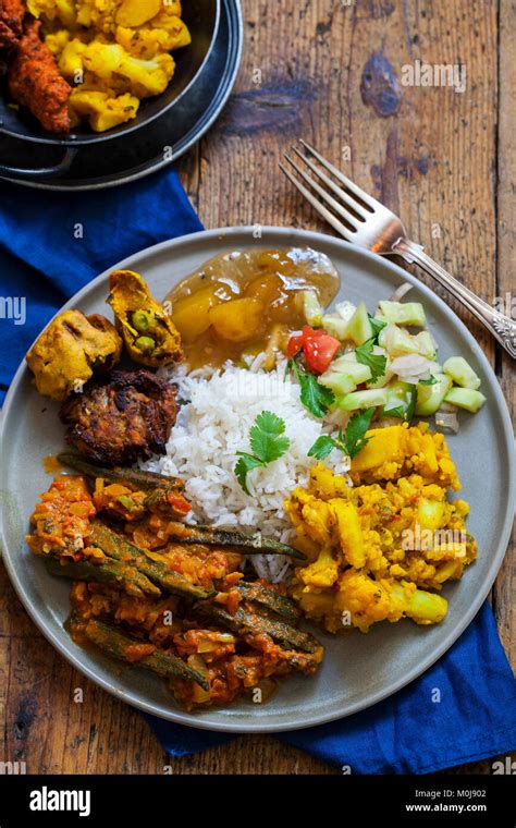 Indian meal with aloo gobi, okra curry, rice and pakoras Stock Photo ...