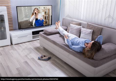 Woman Lying On Sofa Watching Television - Stock image - #25010762 | PantherMedia Stock Agency