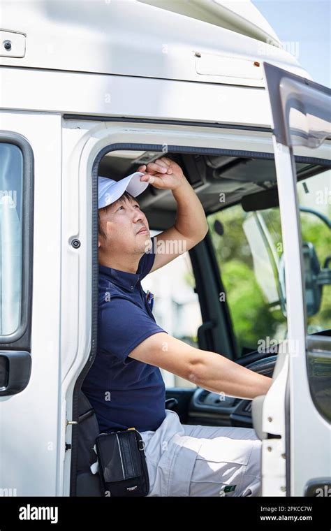 Man looking up at the sky while opening the truck driver's door Stock ...