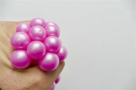 Pink Stress Ball Getting Pressed In Hand Stock Photo - Download Image ...