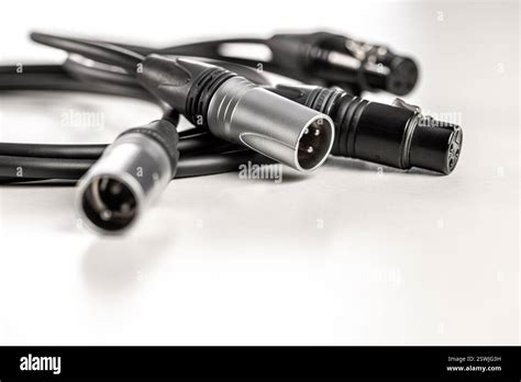 Xlr audio cables connecting on white background Stock Photo - Alamy