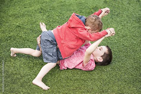 two boys fighting. children on the sports field Stock Photo | Adobe Stock