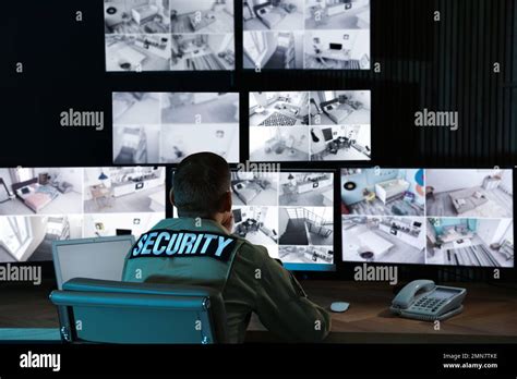 Security guard monitoring modern CCTV cameras in office Stock Photo - Alamy