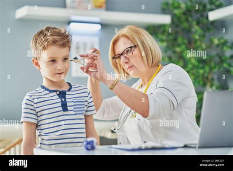 Pediatrician doctor examining little kids in clinic ears check Stock ...