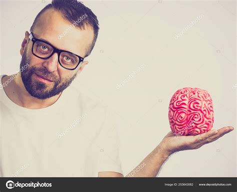 Man looking at human brain — Stock Photo © Voyagerix #253643062