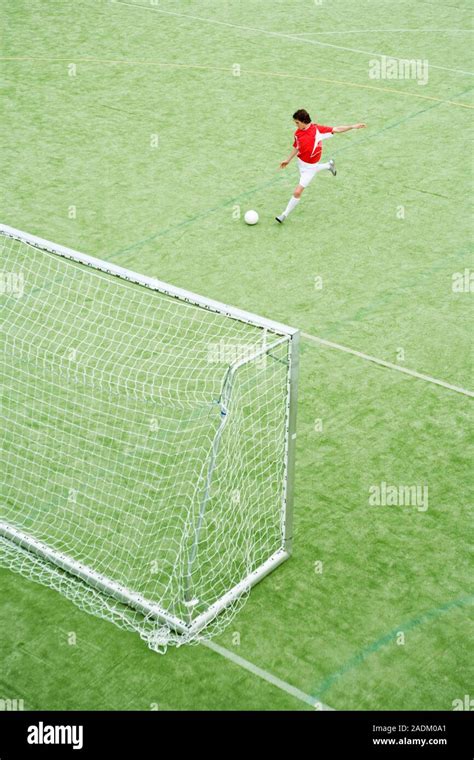 MODEL RELEASED. Footballer preparing to shoot a goal Stock Photo - Alamy