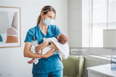 Pediatrician Nurse Taking Care Of Newborn Baby At Hospital Ward High ...
