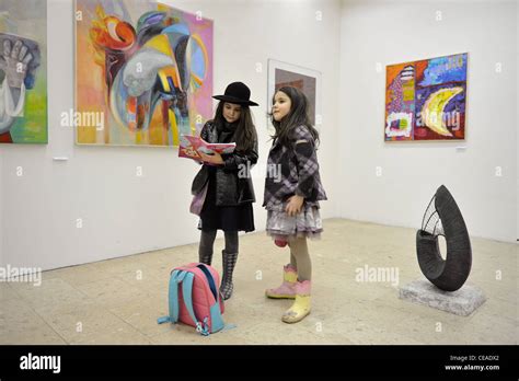 Two girls at exhibition in gallery Stock Photo - Alamy