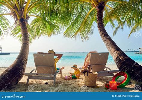 Family with Three Year Old Boy on Beach Stock Photo - Image of sunbed ...
