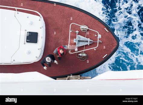 Pilot boat captain boarding ferry at sea in order to guide ferry into ...