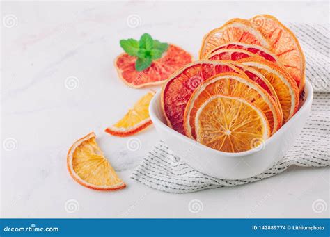 Mixed Dried Citrus Orange and Grapefruit Slices in a White Ceramic Bowl ...