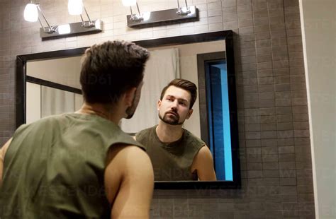 Man Looking In Mirror