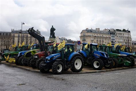 French farmers take tractors back on the streets of Paris in new ...