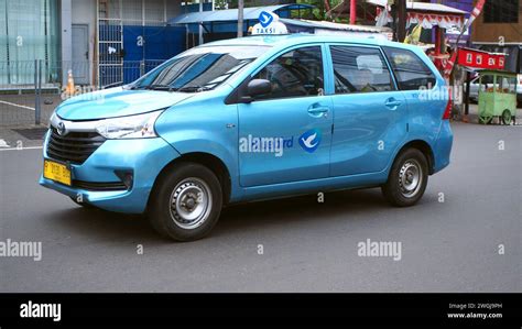 Blue Bird Taxi, Toyota Avanza Transmover car, driving in commercial ...