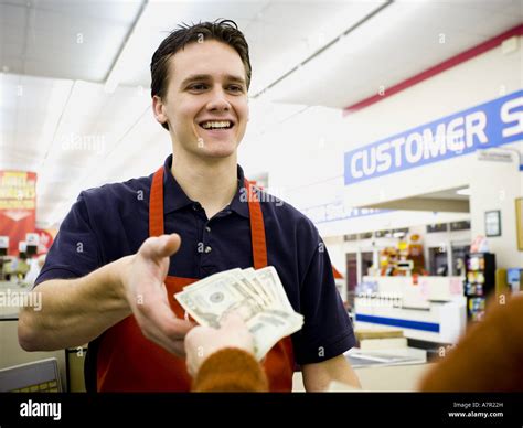 Taking money from cashier hi-res stock photography and images - Alamy