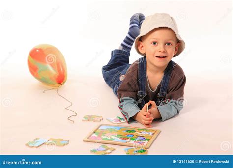 Boy playing with puzzle stock photo. Image of casual - 13141630