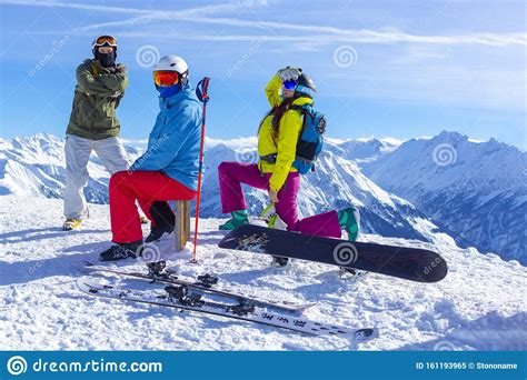 Three Happy Friends Snowboarders and Skier are Having Fun on Ski Slope ...