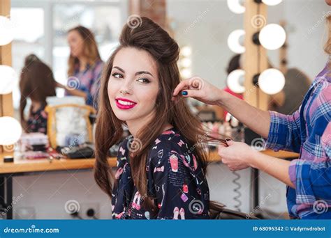 Female Hairdresser Making Hairstyle To Cute Woman in Beauty Salon Stock ...