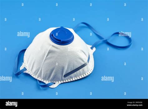 Filtering facepiece respirator on blue background. N95 respirator ...