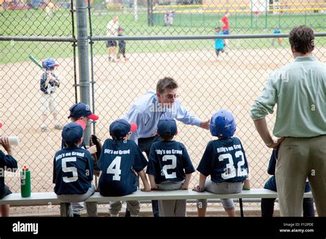 Kids baseball coach enthusiastically talking to his young players ...