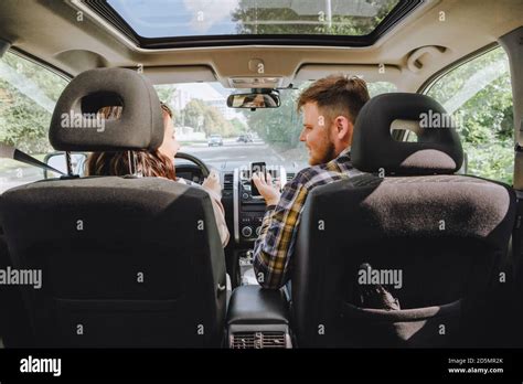 couple sitting in car driving to travel destination Stock Photo - Alamy