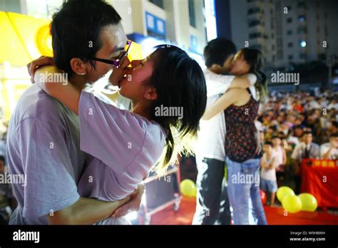 Couples of Chinese lovers kiss each other at a kiss contest to ...