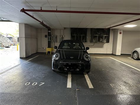 Crowded parking garage and a tiny car that could easily fit into the ...