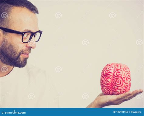 Man looking at human brain stock photo. Image of organ - 130101168