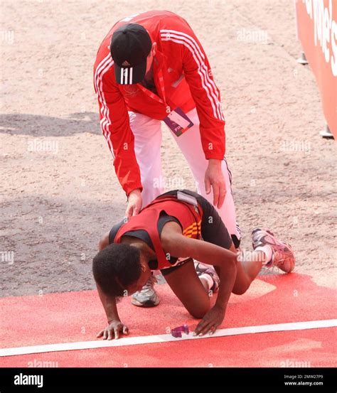 A runner falls at the finish line following the 2011 Virgin London ...