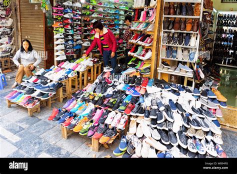 Hanoi, Vietnam - February 21, 2016: Vendors at street market selling ...
