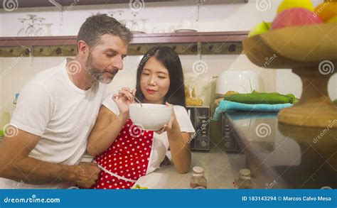 Young Beautiful and Happy Mixed Ethnicity Couple in Love Cooking ...