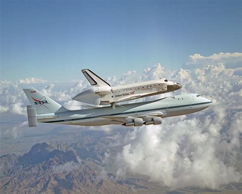 The nasa space shuttle being transported atop the nasa modified Boeing ...