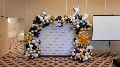 step and repeat backdrop with elegant balloon decor accents | YTEevents